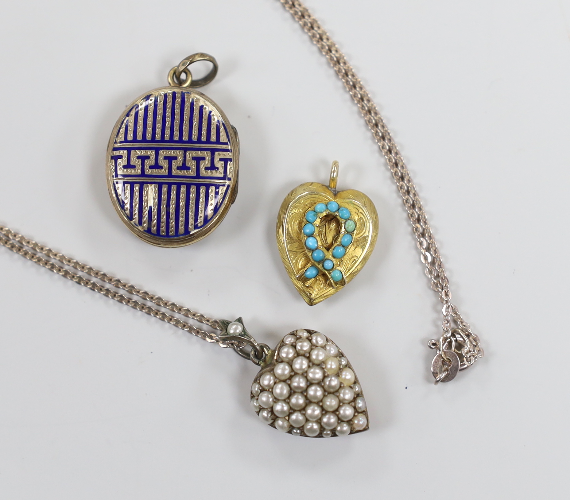 An early 20th century 9ct and seed pearl set heart shaped pendant, 16mm, on a later 925 chain, together with an enamelled locket and turquoise set heart shaped locket.